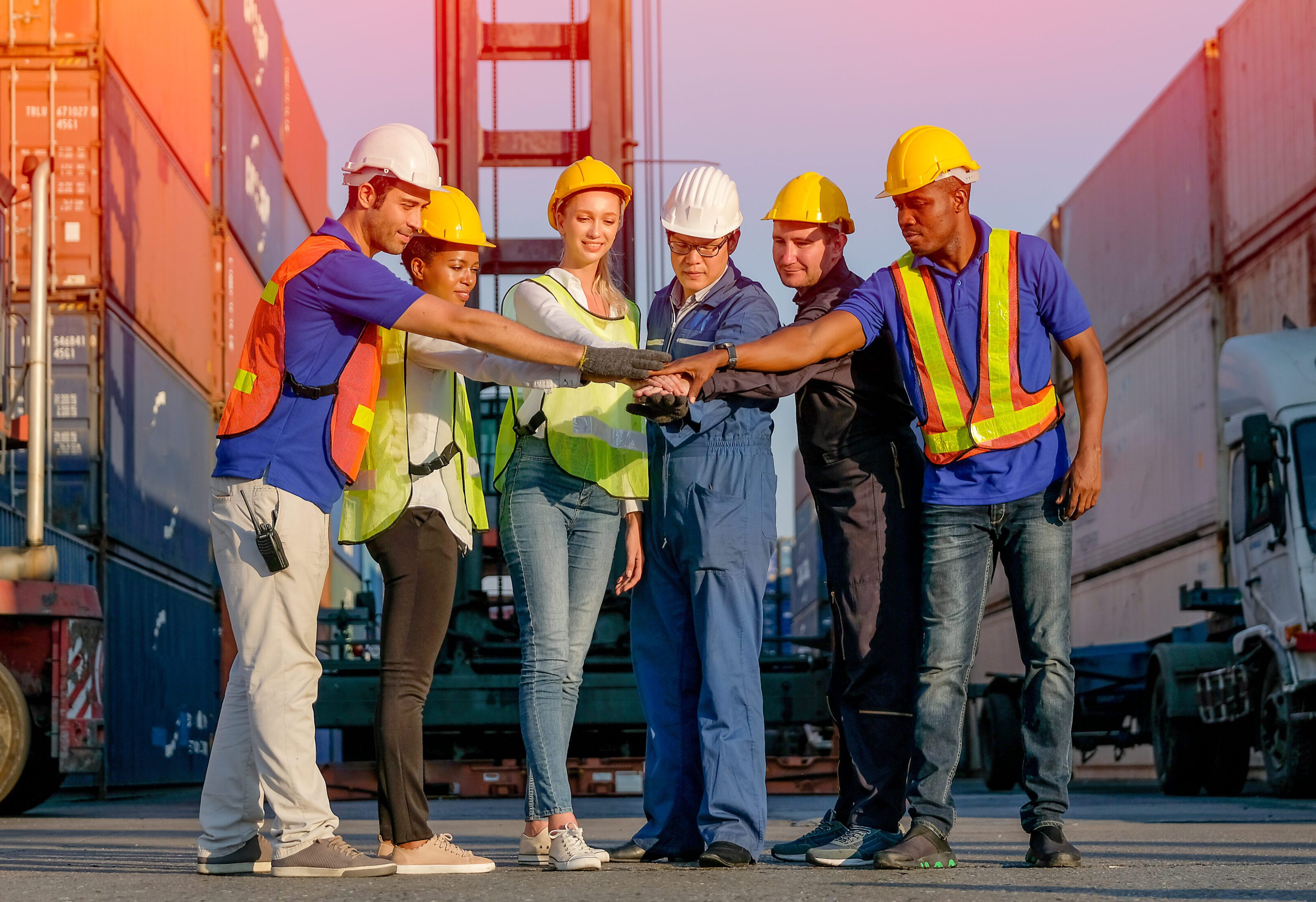 Dock workers joining hands in teamwork.