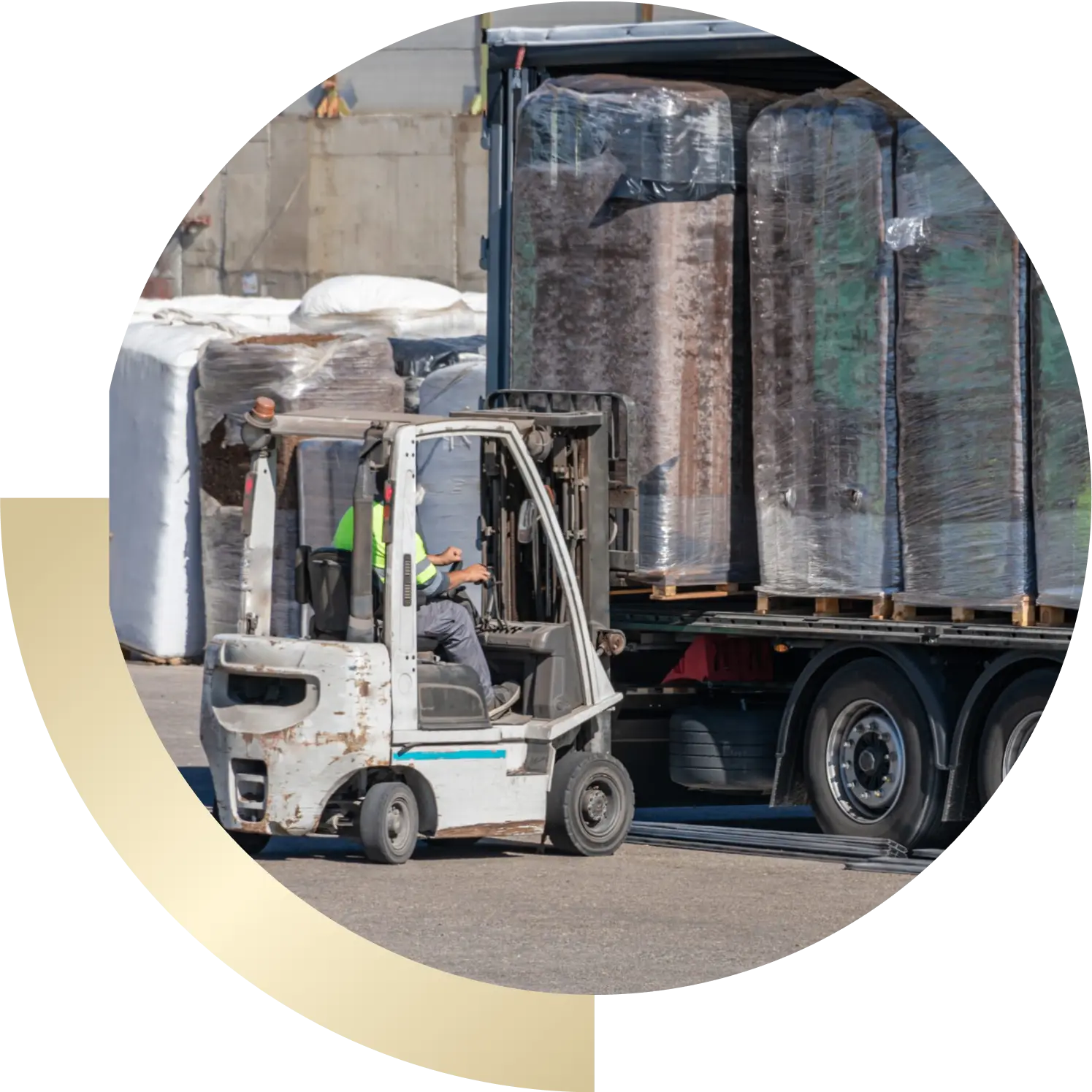 Forklift loading wrapped pallets onto truck trailer